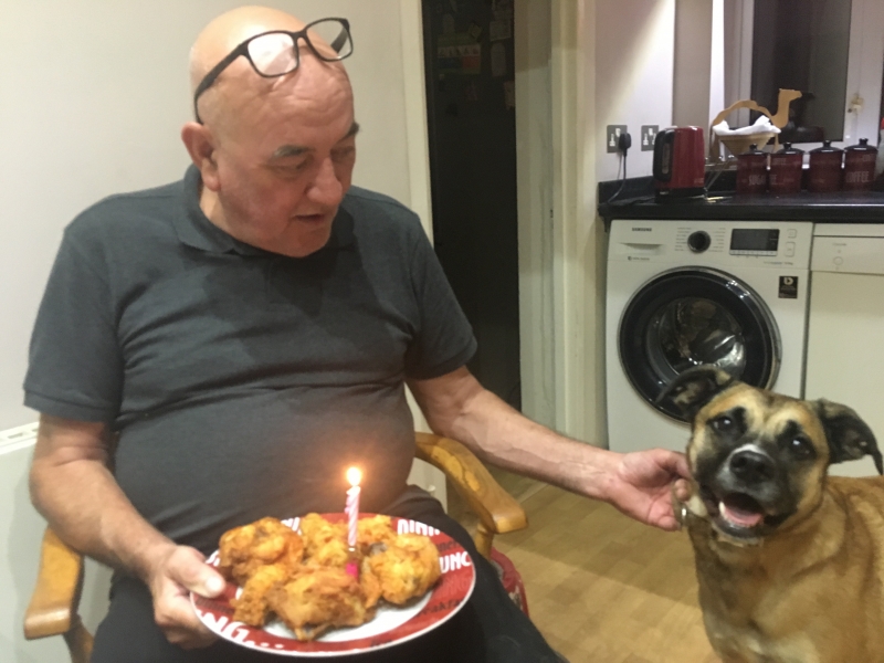 Jim celebrating Petrushka's birthday with their favourite fried chicken.