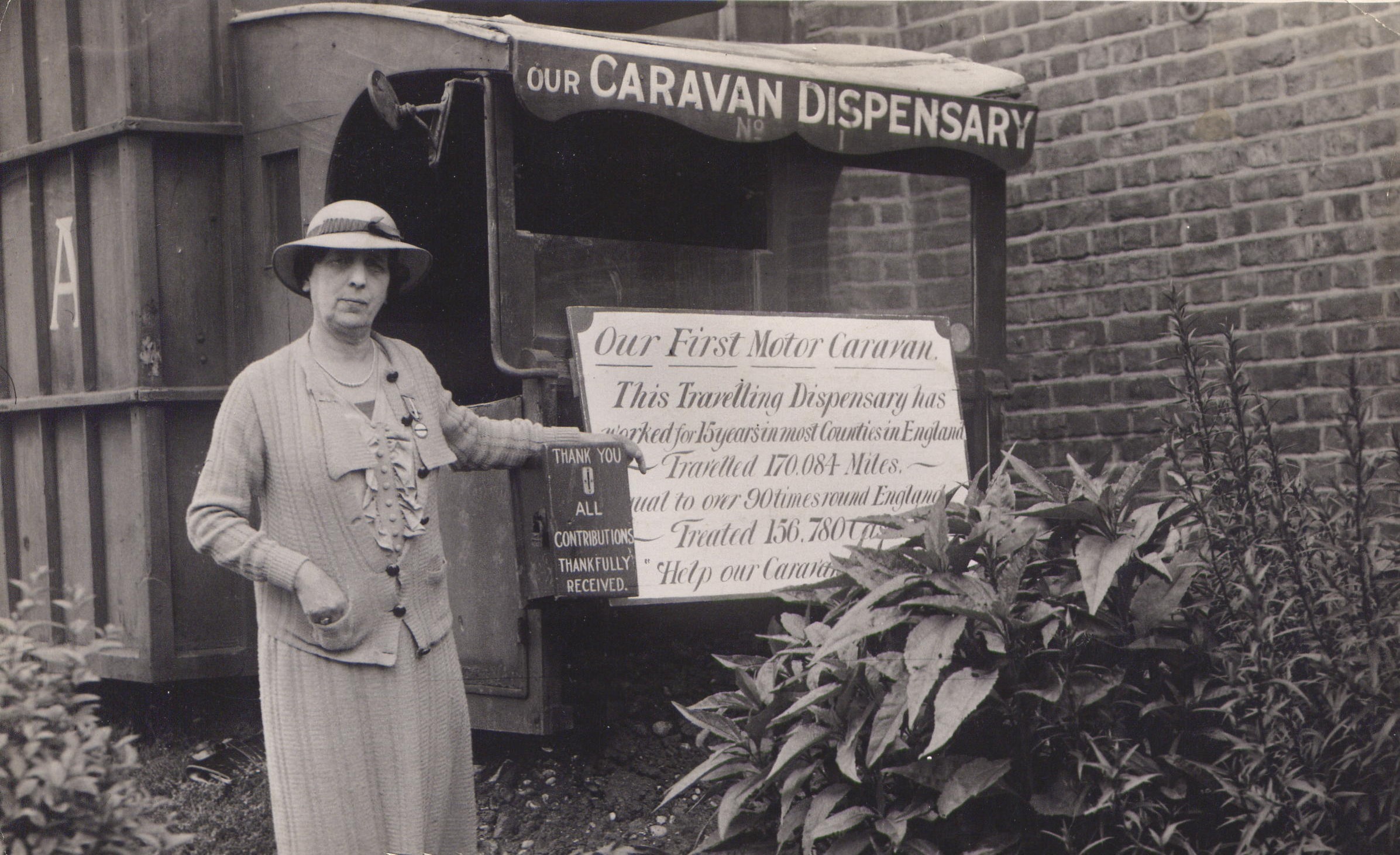 Maria Dickin stands next to a PDSA caravan dispensary